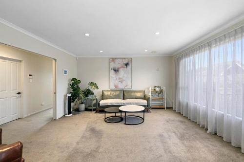 a living room with a couch and a table at Central Lower Hutt Gem - Steps to Queensgate & Station in Lower Hutt