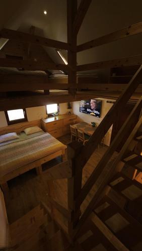 a room with a bed and a television in it at Lake house Amur in Kočevje