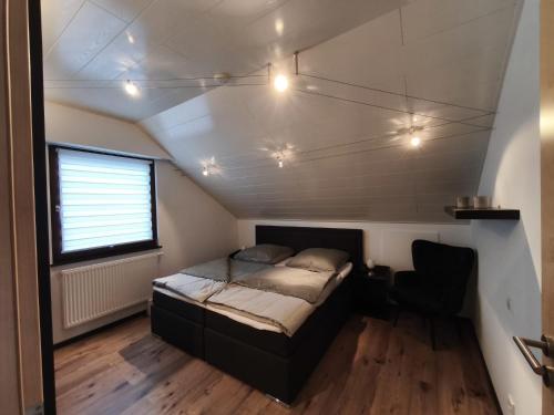 a small bed in a room with a window at Ferienwohnung Andreas in St. Blasien