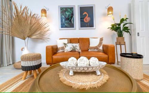 a living room with a couch and a coffee table at Chic Couples Retreat in Port Douglas