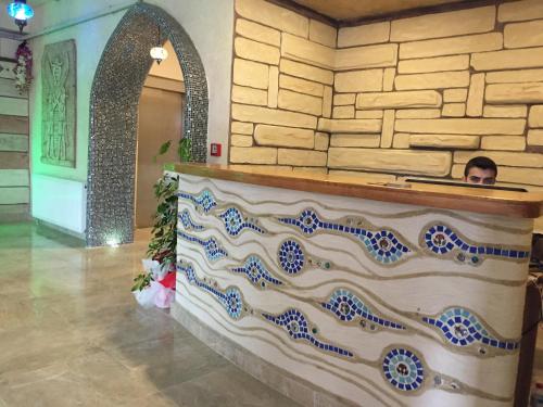 a man is sitting at a counter in a building at Waha Hotel in Bursa