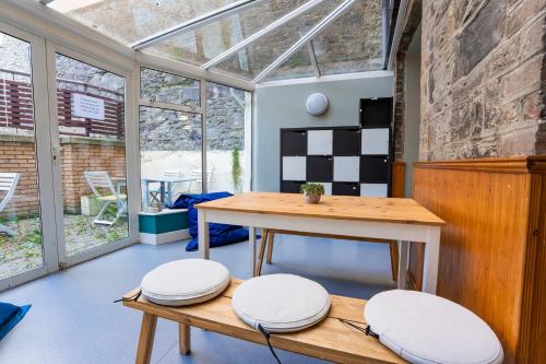 a room with a table and two stools at Bright Ensuite on Lower Baggot in Dublin