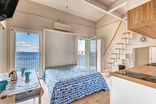 a bedroom with a bed and a view of the ocean at Residenza Rio Marina de luxe in Rio Marina