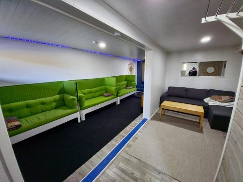a living room with green couches and a couch at Greek house in Salo