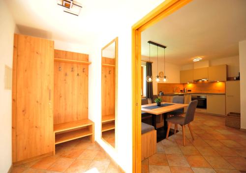 a kitchen and dining room with a table and chairs at Apart am Brunnen in Ried im Oberinntal