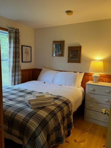 Postel nebo postele na pokoji v ubytování Bar Harbor Cottages & Suites