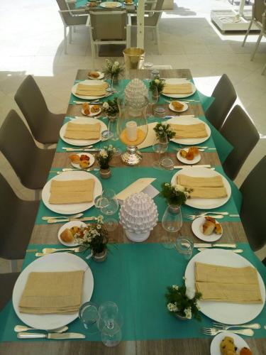a long table with plates of food on it at La Fiermontina Luxury Home Hotel in Lecce