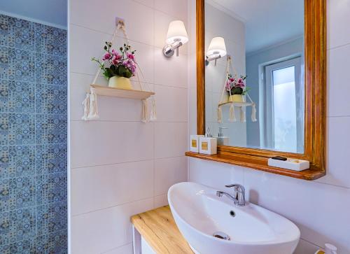 a bathroom with a sink and a mirror at Casa EMMA in Jurilovca