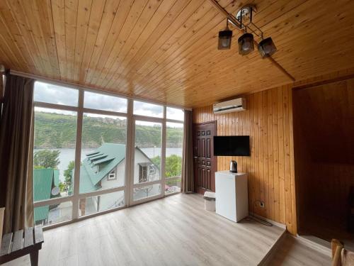 a large living room with a large window at Family House in Makarovka