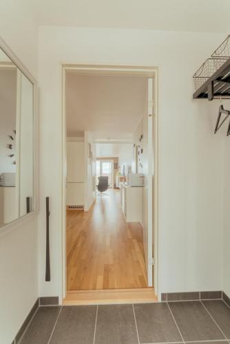 an open door to a hallway in a house at 2 BR Ocean and City View Apartment in Tórshavn