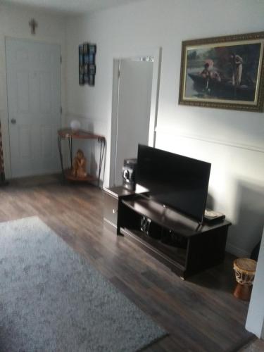 a living room with a black piano in a room at Près du fleuve in Rimouski
