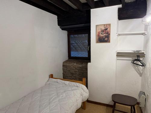 a bedroom with a bed and a stone wall at Le Foyer Ardennais in Trois-Ponts