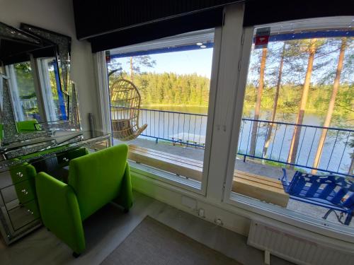 a room with two windows and a view of a lake at Greek house in Salo