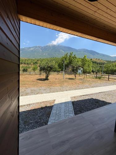 a window in a house looking out at the mountains at Shtegu I Gjelber- Wood Rooms 