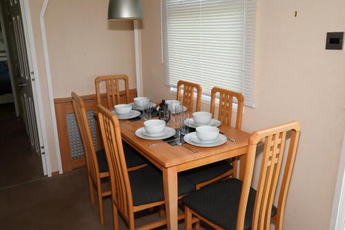 a wooden table with chairs and a dining room at Shelly's Stay in Port Carlisle