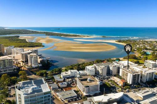 an aerial view of a city and the ocean at The Cosmopolitan Suite in Maroochydore