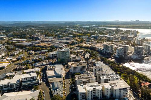 an aerial view of a city with a river and buildings at The Cosmopolitan Suite in Maroochydore