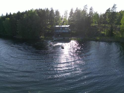 an aerial view of a house on a lake at Greek house in Salo