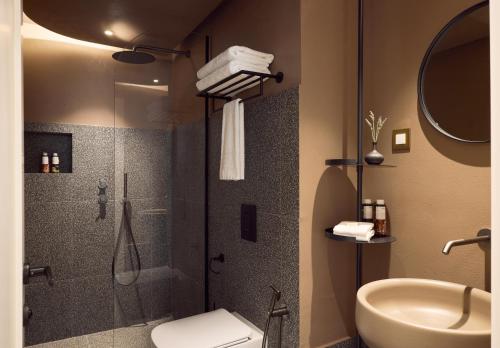 a bathroom with a shower and a toilet and a sink at A for Athens in Athens
