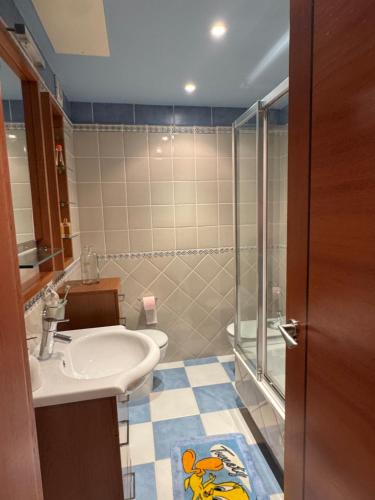 a bathroom with a sink and a shower at Playa Castro in Aguiño