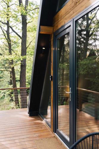 an entrance to a house with a glass door at Juniper Chalet Mátra in Mátraszentimre