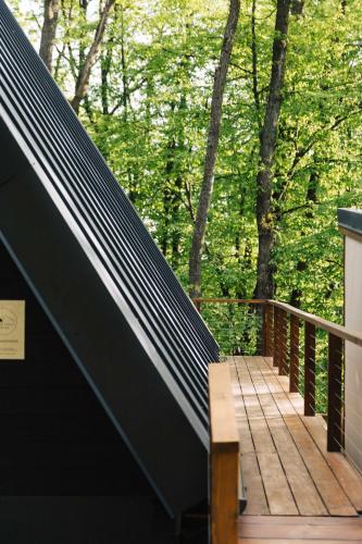 a wooden deck with a bench on top of it at Juniper Chalet Mátra in Mátraszentimre
