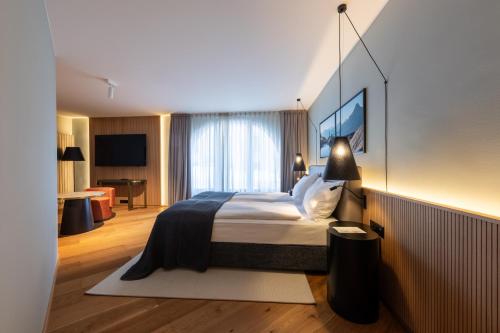 a hotel room with a bed and a desk at Hotel Rosatsch in Pontresina