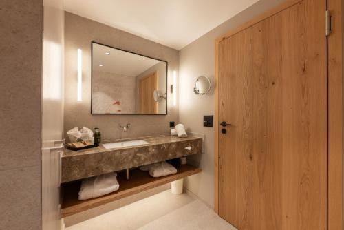 a bathroom with a sink and a mirror at Hotel Rosatsch in Pontresina