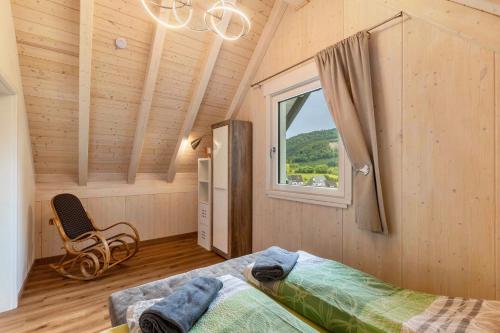 a bedroom with a bed and a window at Haus Traumblick und Alpenzauber in Lennestadt