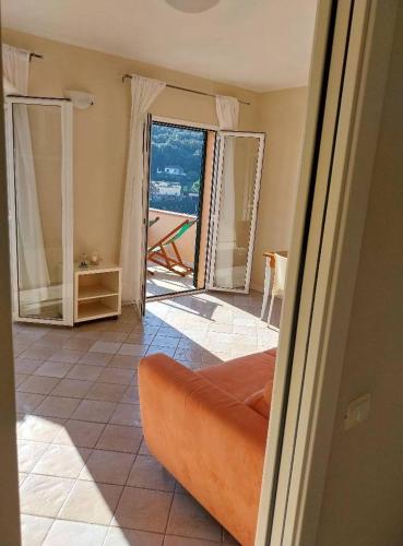 a living room with a couch and a view of the ocean at Monolocale Solana 6 in Cavo