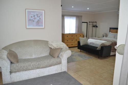 a living room with a couch and a bed at The Starling Room in East London