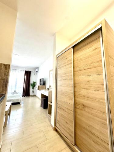 a large wooden sliding door in a room at Sunrise Apart-Hotel in Ulcinj