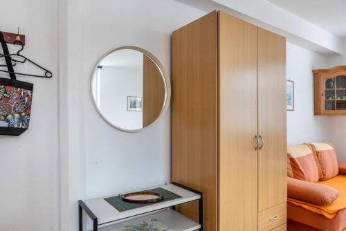a room with a wooden cabinet and a mirror at Ferienwohnung Jacobi Kurfürst in Naumburg