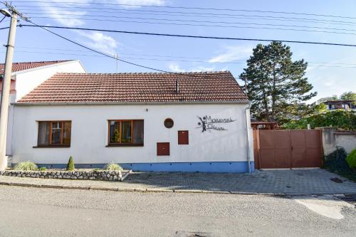 a white house with graffiti on the side of it at Resort Zajíci ze Zaječí in Zaječí