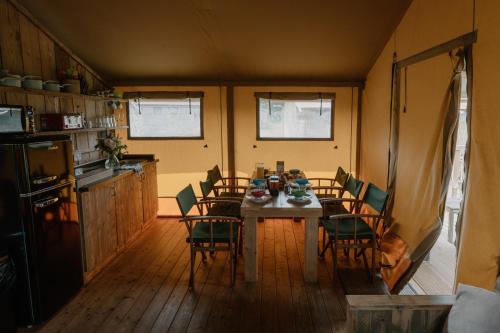 a kitchen with a table and chairs in a room at Butterfly Riverdale Yorkshire in West Tanfield