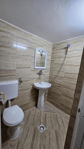 a bathroom with a toilet and a sink at Obelisc Costinesti in Costinesti