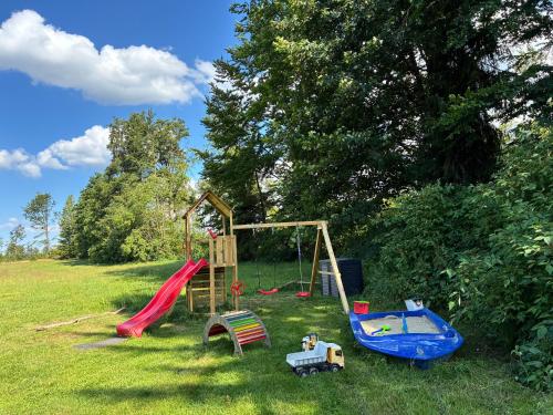a group of playground equipment in a field at Pension und Gastwirtschaft Mareile am Rennsteig in Rodacherbrunn