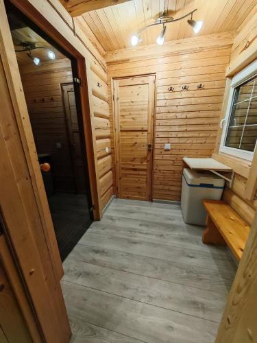 a bathroom in a log cabin with a sink at Atokvėpis Alantos kaime in Alanta