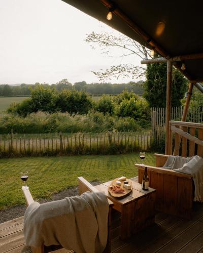 a table and chairs on a deck with a view at Butterfly Riverdale Yorkshire in West Tanfield
