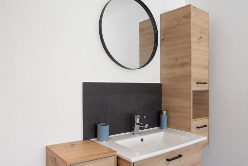 a bathroom with a sink and a mirror at Ferienwohnung Böhler in Doren