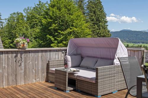 a patio with a couch and a table on a deck at Ferienwohnung Böhler in Doren