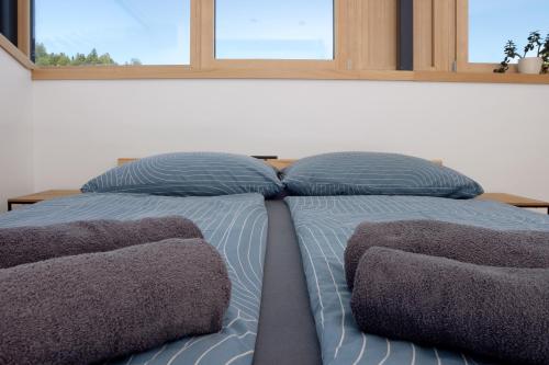 a bedroom with a bed with pillows and a window at Ferienwohnung Böhler in Doren