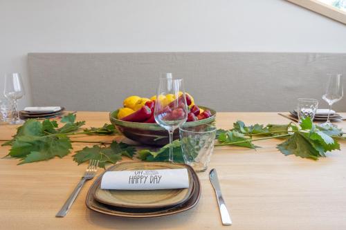 a table with a bowl of fruit and a plate with a happy my sign at Ferienwohnung Böhler in Doren