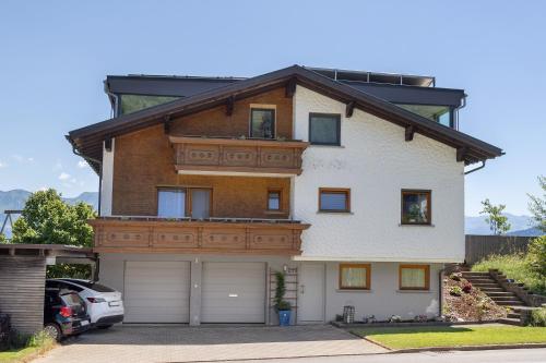 a large white house with a wooden roof at Ferienwohnung Böhler in Doren