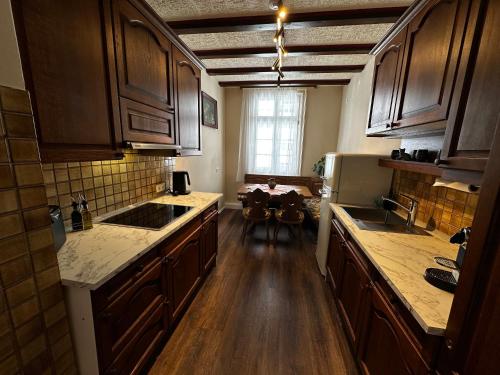a kitchen with wooden floors and wooden cabinets at Haus der Weine in Rüdesheim am Rhein