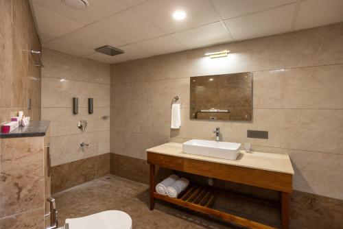 a bathroom with a sink and a shower at Nexstay De' Malabaricus in Kozhikode