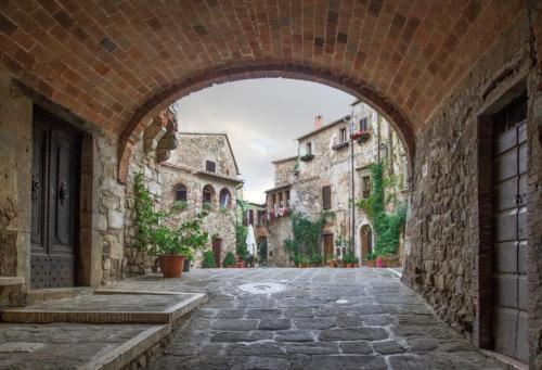 an archway in an alley in an old town at La Gatta in Montemerano