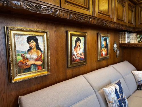 a living room with a couch and paintings on the wall at Haus der Weine in Rüdesheim am Rhein