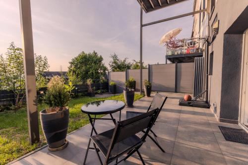 a patio with a table and chairs on a balcony at Rhein-Lodge in Urbar-Mayen-Koblenz