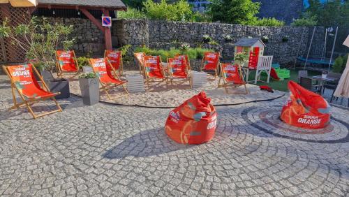 a group of chairs and orange bags on a patio at Orlicka Skała in Zieleniec